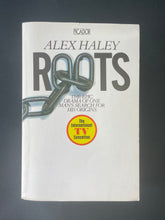 Load image into Gallery viewer, Roots by Alex Haley: photo of the front cover which shows very minor scuff marks along the edges, and minor creasing running down the left-hand side of the book, parallel to the spine.
