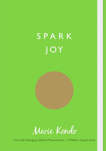 Book cover of 'Spark Joy' by Marie Kondo with a green background and brown circle.