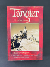 Load image into Gallery viewer, Tangier-City of the Dream by Iain Finlayson: photo of the front cover which shows very minor scuff marks along the edges, and minor creasing on the left-hand side, parallel to the spine.
