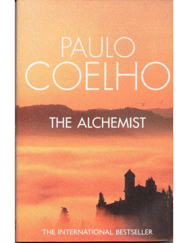 Book cover of 'The Alchemist' by Paulo Coelho with a sunset and silhouette design.