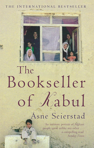 Book cover of 'The Bookseller of Kabul' with a window scene and child sitting on a box.