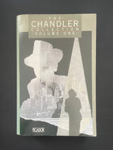 Load image into Gallery viewer, Book cover of &#39;The Chandler Collection Volume One&#39; by Raymond Chandler with a silhouette design on a dark background. The photo shows minor scuff marks and scratching, and a minor crease on the bottom-right corner.
