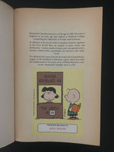 Load image into Gallery viewer, The Chandler Collection-Volume Three by Raymond Chandler: photo of the first page which has a large Peanuts sticker on it with the name of a previous owner along the bottom.
