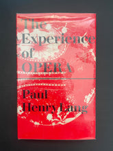 Load image into Gallery viewer, The Experience of Opera by Paul Henry Lang: photo of the front cover which shows air pockets under the clear plastic dust jacket.
