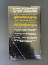 Load image into Gallery viewer, Book cover of &#39;The Falcon and the Snowman&#39; with promotional text on a dark background. Photo of the back cover which shows obvious creasing and scuff marks.
