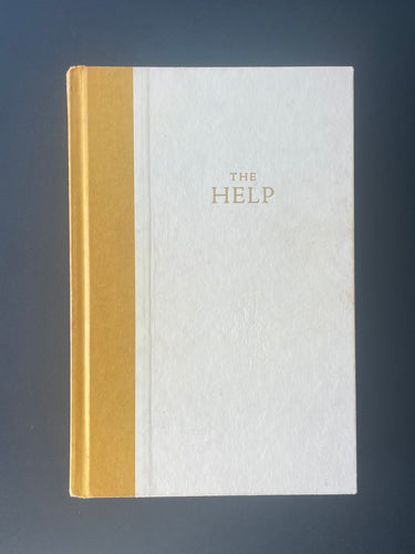 The Help by Kathryn Stockett: photo of the front cover which shows very minor scuff marks along the edges.