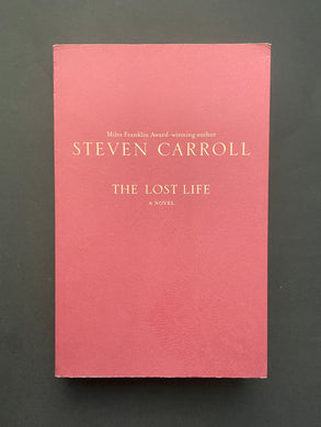 The Lost Life by Steven Carroll: photo of the front cover which shows long creases running down the length over of the cover, and minor creasing on the top-right corner.