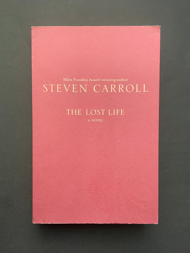 The Lost Life by Steven Carroll: photo of the front cover which shows long creases running down the length over of the cover, and minor creasing on the top-right corner.