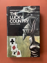 Load image into Gallery viewer, The Lucky Country by Donald Horne: photo of the front cover which shows minor scuff marks along the edges.
