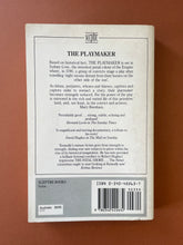 Load image into Gallery viewer, The Playmaker by Thomas Keneally: photo of the back cover which shows minor scuff marks and scratching.
