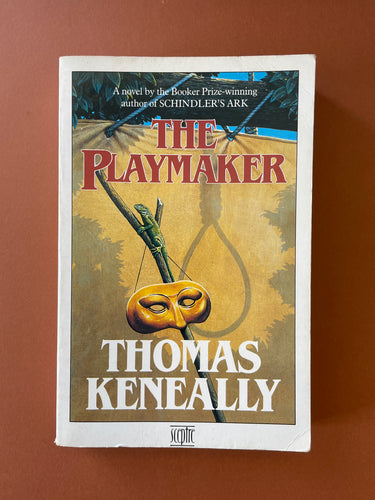 The Playmaker by Thomas Keneally: photo of the front cover which shows a fair amount of creasing and scratching, and some minor scuff marks. 