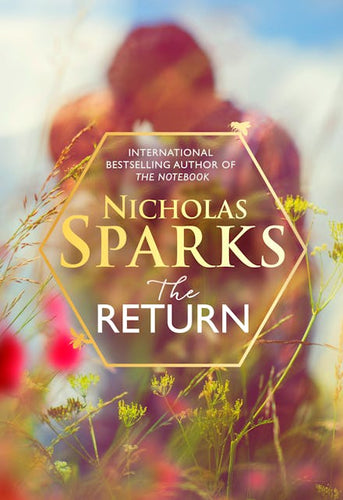 Book cover of 'The Return' by Nicholas Sparks with blurred background of red flowers and greenery.