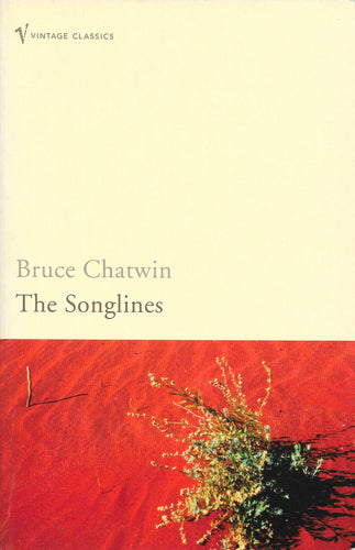 Book cover of 'The Songlines' by Bruce Chatwin with a red and beige background.