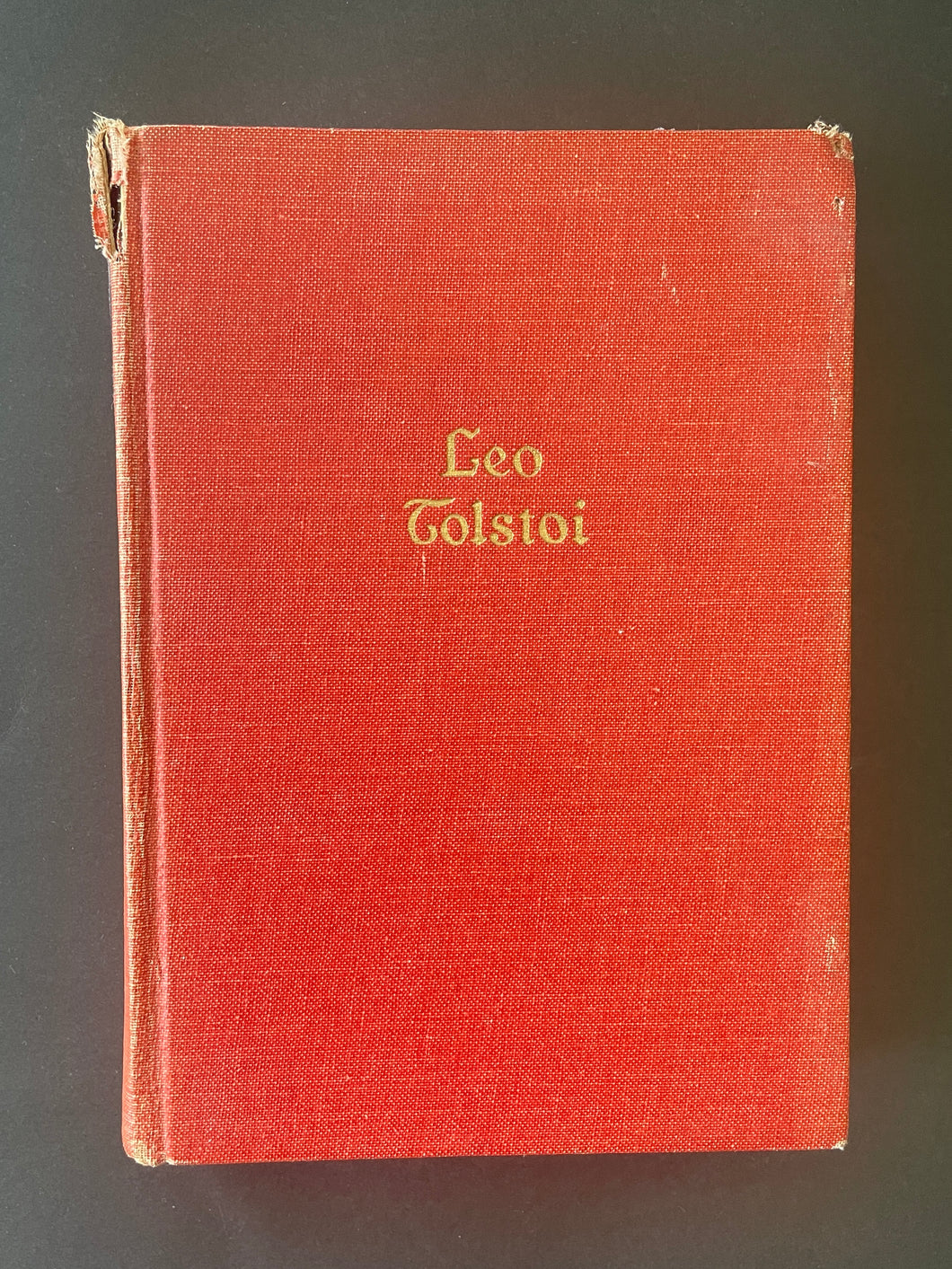 The Works of Leo Tolstoi by Leo Tolstoi: photo of the front cover which shows scuff marks along the edges, and a tear on the top-left corner.