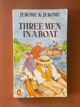 Load image into Gallery viewer, Three Men in a Boat by Jerome K. Jerome: photo of the front cover which shows a fair amount of creasing, scratching, and scuff marks.
