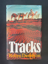 Load image into Gallery viewer, Tracks by Robyn Davidson: photo of the front cover which shows creasing and scuff marks along th edges.
