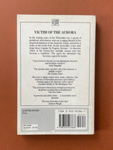 Load image into Gallery viewer, Victim of the Aurora by Thomas Keneally: photo of the back cover which shows minor scuff marks and scratching.
