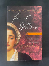 Load image into Gallery viewer, Book cover of &#39;Year of Wonders&#39; by Geraldine Brooks on a dark background. There is creasing on the bottom-right corner.
