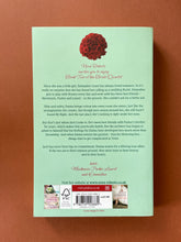 Load image into Gallery viewer, Bed of Roses by Nora Roberts: photo of the back cover which shows very minor scuff marks and creasing along the edges.
