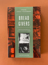 Load image into Gallery viewer, Bread Givers-A Novel by Anzia Yezierska: photo of the front cover which shows creasing on the top-right corner.

