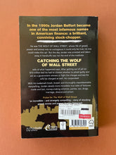 Load image into Gallery viewer, Catching the Wolf of Wall Street by Jordan Belfort: photo of the back cover which shows very minor (barely visible) scuff marks along the edges.
