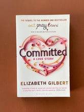 Load image into Gallery viewer, Committed-A Love Story by Elizabeth Gilbert: photo of the front cover which shows a very minor crease starting at the top-left corner and running over the word THE.
