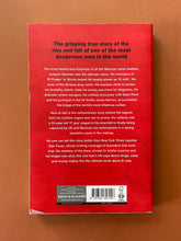 Load image into Gallery viewer, El Jefe-The Stalking of Chapo Guzman by Alan Feuer: photo of the back cover which shows very minor scuff marks along the edges, and a small patch of laminating that has come unstuck on the bottom-left corner.
