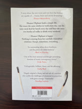 Load image into Gallery viewer, Eleanor Oliphant is Completely Fine by Gail Honeyman book: photo of the back cover, which shows a patch ripped off at the top-right corner.
