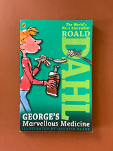 Load image into Gallery viewer, George&#39;s Marvellous Medicine by Roald Dahl: photo of the front cover which shows a small pen mark to the right of George&#39;s face. There is also very minor scuff marks along the edges, which have cause the corners to bend upwards very slightly.

