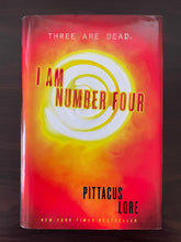 Load image into Gallery viewer, I Am Number Four by Pittacus Lore book: photo of front cover. There are very minor scuff marks along the edges of the dust cover.
