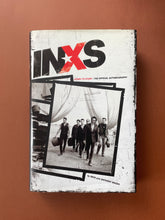 Load image into Gallery viewer, INXS-Story to Story by Anthony Bozza: photo of the front cover which shows very minor (barely noticeable) scuff marks along the edges.
