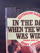 Load image into Gallery viewer, In the Days When the World Was Wide by Henry Lawson book: photo of tearing on the top-left corner of the dust jacket.
