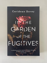 Load image into Gallery viewer, In the Garden of the Fugitives by Ceridwen Dovey: photo of the front cover which shows very minor scuff marks along the edges.

