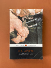 Load image into Gallery viewer, Lady Chatterley&#39;s Lover by D. H. Lawrence: photo of the front cover which shows very minor scuff marks along the edges, and obvious creasing on the the bottom-right corner of the book.
