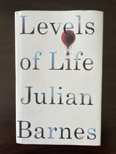 Load image into Gallery viewer, Levels of Life by Julian Barnes book: photo of front cover, which shows a small handful of very small blobs of copper discolouring, and the white of the cover has minor smudges of discolouring due to age.
