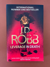 Load image into Gallery viewer, Leverage in Death by J. D. Robb: photo of the front cover which shows very minor creasing on the bottom-right corner.
