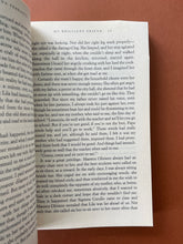 Load image into Gallery viewer, My Brilliant Friend by Elena Ferrante: photo of page 45 which shows a minor crease on the top-right corner. Pages 45/46 are the only pages with creasing in the whole book.
