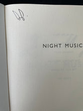 Load image into Gallery viewer, Night Music by Jojo Moyes: photo of the title page which shows the initials of a previous owner written in black pen on the top-left corner.
