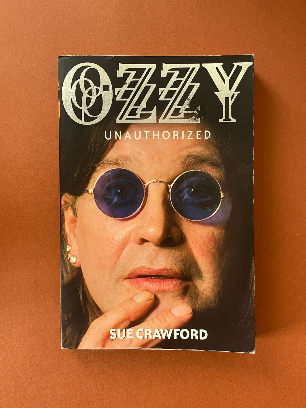 Ozzy (Unauthorized) by Sue Crawford: photo of the front cover which shows scuff marks and very minor creasing along the edges.