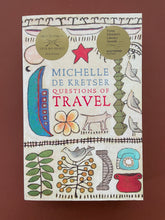 Load image into Gallery viewer, Questions of Travel by Michelle De Kretser: photo of front cover which shows very minor (barely visible) creasing running down the page, near the spine.
