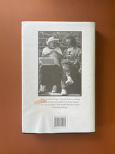 Load image into Gallery viewer, Searching for Schindler by Tom Keneally: photo of the back cover which shows scuff marks along the edges, and wrinkling on the bottom of the dust jacket.
