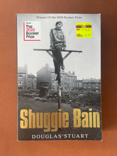 Load image into Gallery viewer, Shuggie Bain by Douglas Stuart: photo of the front cover which shows minor scuff marks and creasing along the edges.
