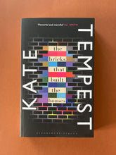 Load image into Gallery viewer, The Bricks that Built the Houses by Kate Tempest: photo of the front cover which shows very minor (barely visible) scuff marks along the edges.
