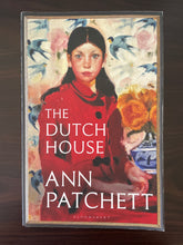 Load image into Gallery viewer, The Dutch House by Ann Patchett book: photo of the front cover, which has very minor scuff marks along the edges, and minor vertical creasing at the bottom left and right corners (not very noticeable).
