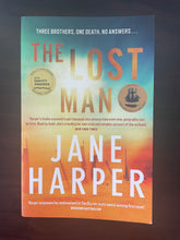 Load image into Gallery viewer, The Lost Man by Jane Harper book: photo of front cover. There is a very minor scuff mark on the bottom-right corner of the cover. There is also a very thin crease on the &#39;A&#39; and &#39;N&#39; of the word &#39;MAN&#39;; and a very thin crease on the &#39;N&#39; and &#39;E&#39; of the word &#39;JANE&#39;. The creases are barely visible.
