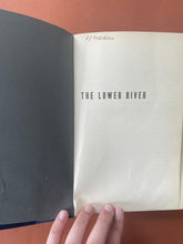 Load image into Gallery viewer, The Lower River by Paul Theroux: photo of the second page which shows that someone has written: F/THEROU on the top-left corner of the page in black pen.
