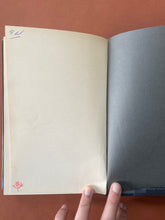 Load image into Gallery viewer, The Lower River by Paul Theroux: photo of the second last page in the book which has been initialled in blue pen on the top-left corner of the page, and stamped on the bottom-left corner.
