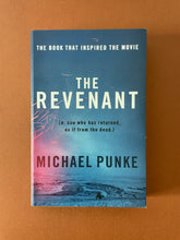 Load image into Gallery viewer, The Revenant by Michael Punke: photo of the front cover which shows very minor (barely visible) scuff marks along the edges.
