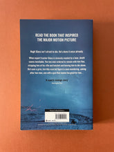 Load image into Gallery viewer, The Revenant by Michael Punke: photo of the back cover which shows very minor (barely visible) scuff marks along the edges, and very minor creasing to the right of the barcode box.
