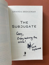 Load image into Gallery viewer, The Subjugate by Amanda Bridgeman: photo of the title page which is inscribed with the personal message: &#39;Gary, Enjoy solving the crime! (signature) 2019 supanova&#39; in black texta.
